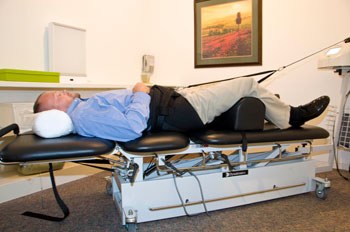 Patient lying on the clinic's spinal decompression table
